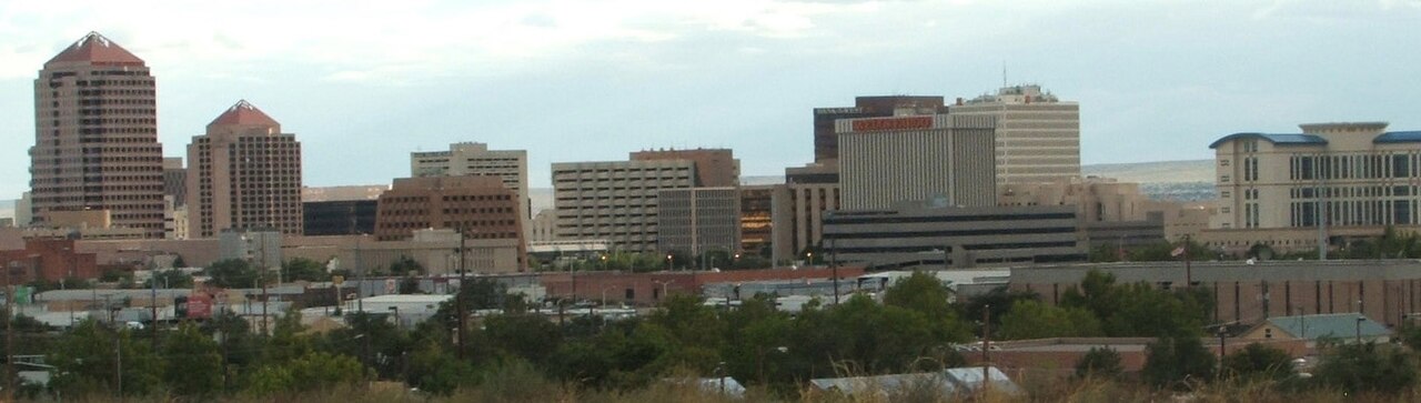 The Albuquerque skyline with the Sandia Mountains behind it — cover of WELCOME Albuquerque, the Albuquerque New Mexico city magazine